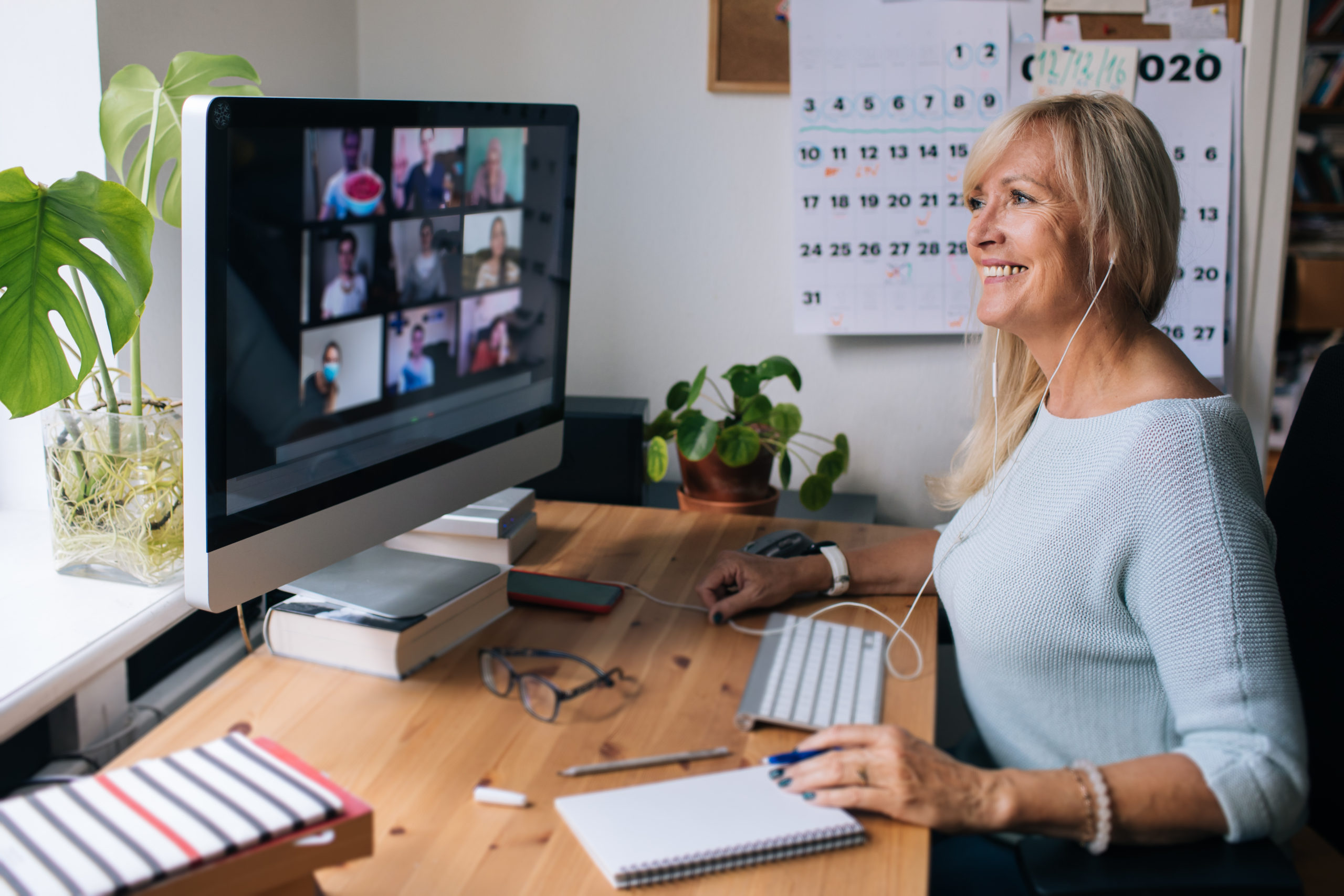 Smiling mature woman having video call via computer in the home